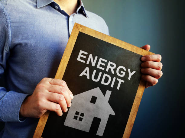 Man holds Energy Audit board.